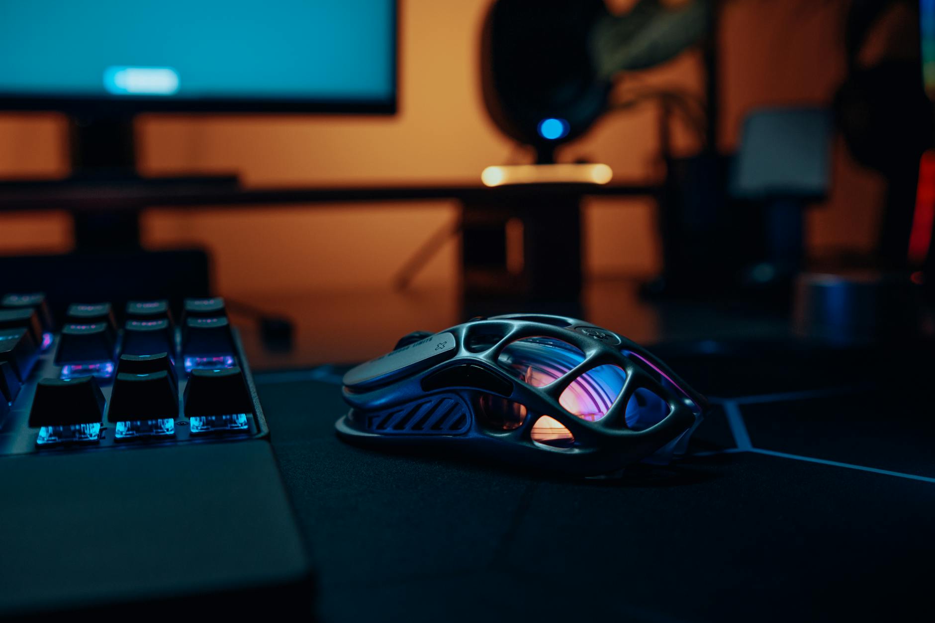 futuristic gaming mouse on neon lit desktop